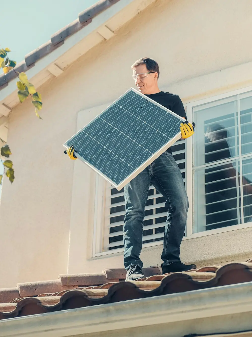Worker installing solar panel